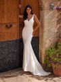 Bride in V-neckline ivory crepe wedding dress with surplice bodice Bride in V-neckline ivory crepe wedding dress with surplice bodice