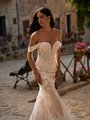 Bride walking in boho southwestern lace wedding dress with sweetheart neckline and off the shoulder sleeves Bride walking in boho southwestern lace wedding dress with sweetheart neckline and off the shoulder sleeves